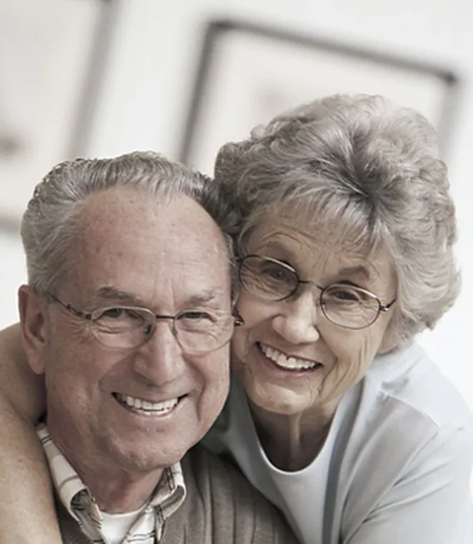 A senior couple at home together, supported by around-the-clock care